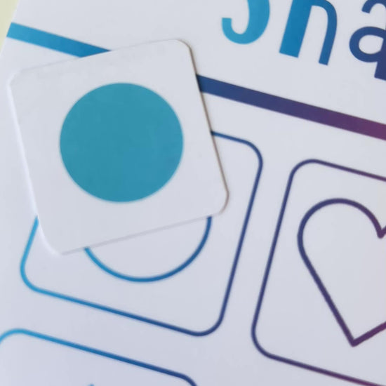 Shape matching learning mat with colourful shapes and text on a gradient background