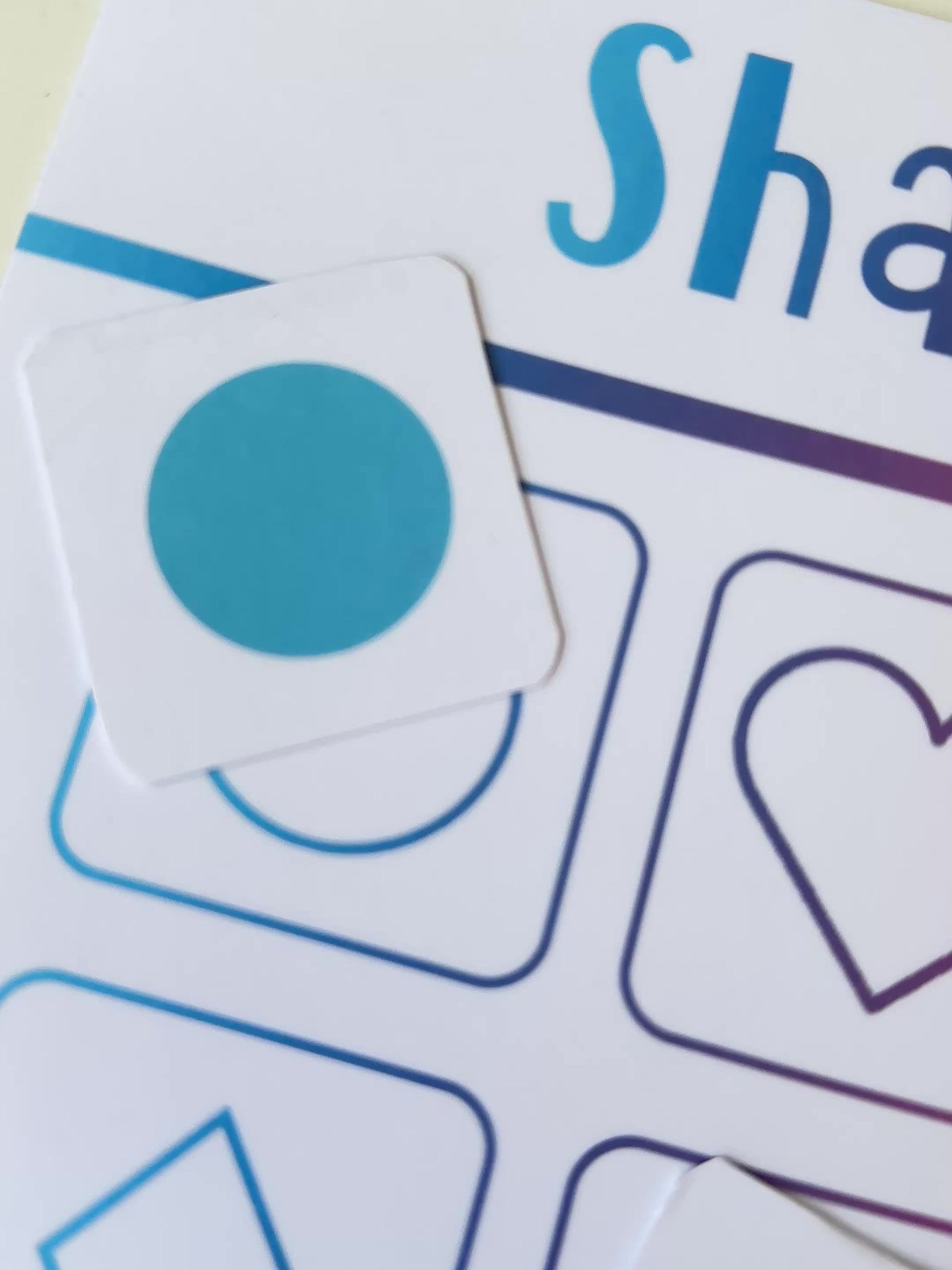 Shape matching learning mat with colourful shapes and text on a gradient background
